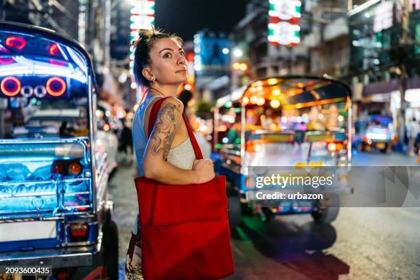 young female tourist in chinatown in bangkok at night - bangkok market stock pictures, royalty-free photos & images