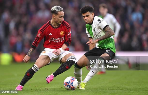 Antony of Manchester United is challenged by Luis Diaz of Liverpool during the Emirates FA Cup Quarter Final match between Manchester United and...