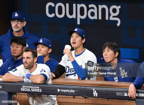 Shohei Ohtani of Los Angeles Dodgers cheers for teamate at the dugout in the bottom of the third inning during the exhibition game between Team Korea...