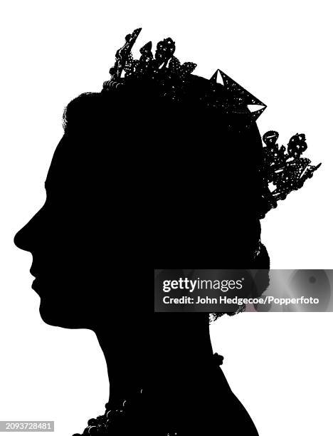 Queen Elizabeth II posed seated in profile in silhouette wearing a crown in the Buckingham Palace music room in London in 1966. The photographer was...