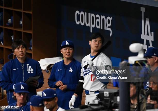 Ippei Mizuhara ,Yamamoto Yoshinobu, Shohei Ohtani of Los Angeles Dodgers talks in the bottom of the third inning during the exhibition game between...