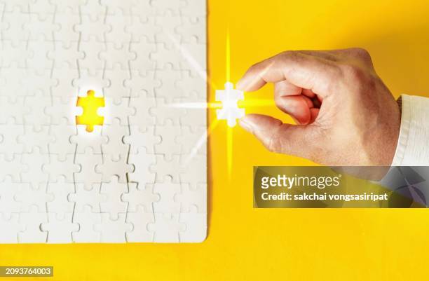 a final jigsaw puzzle piece into a last blank, iq test, successful problem solving concept - finals game one stock pictures, royalty-free photos & images
