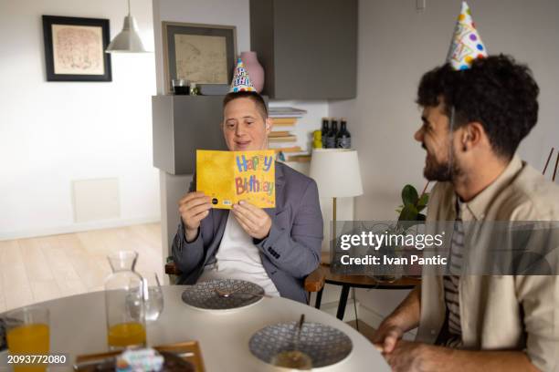 reading a birthday card! - man reading card stock pictures, royalty-free photos & images