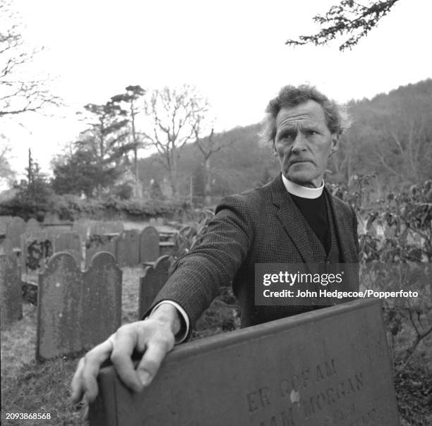 Welsh poet and Anglican clergyman Ronald Stuart Thomas , known as R S Thomas, in a graveyard in the village of Eglwysfach near Machynlleth in Wales...