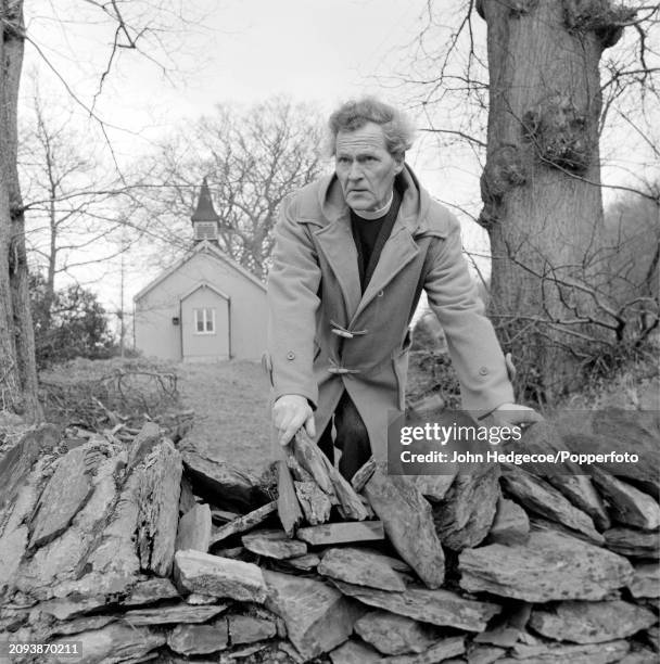 Welsh poet and Anglican clergyman Ronald Stuart Thomas , known as R S Thomas, in the grounds of a chapel in the village of Eglwysfach near...