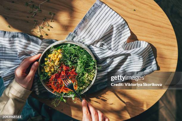 woman holding bowl with products for heart-healthy diet, closeup - microvegetal imagens e fotografias de stock