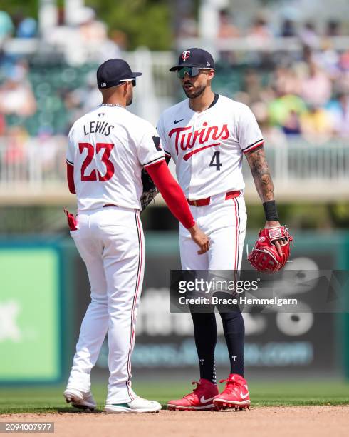 Royce Lewis and Carlos Correa of the Minnesota Twins look on during a spring training game against the Tampa Bay Rays on March 16, 2024 at the Lee...