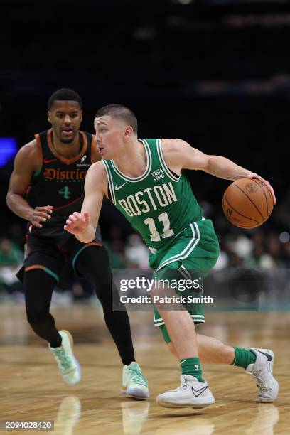 Payton Pritchard of the Boston Celtics dribbles past Jared Butler of the Washington Wizards during the second half at Capital One Arena on March 17,...