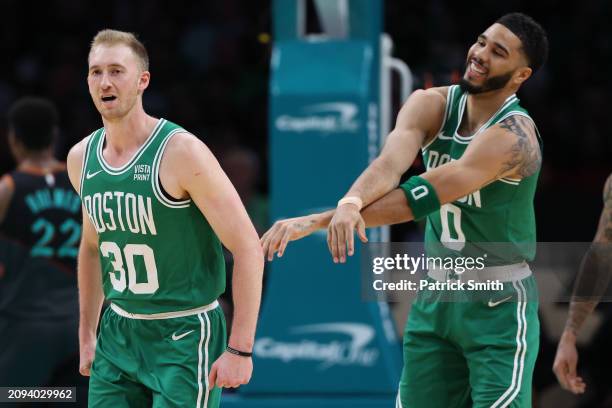 Sam Hauser of the Boston Celtics celebrates after scoring a three-point basket with teammate Jayson Tatum against the Washington Wizards during the...