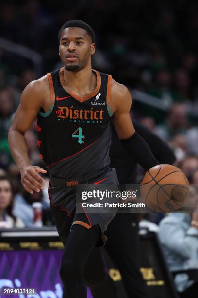 Jared Butler of the Washington Wizards dribbles the ball against the Boston Celtics during the first half at Capital One Arena on March 17, 2024 in...