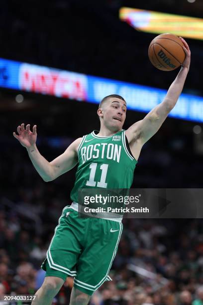 Payton Pritchard of the Boston Celtics rebounds the ball against the Washington Wizards during the first half at Capital One Arena on March 17, 2024...