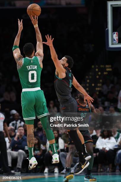 Jayson Tatum of the Boston Celtics shoots in front of Anthony Gill of the Washington Wizards during the first half at Capital One Arena on March 17,...