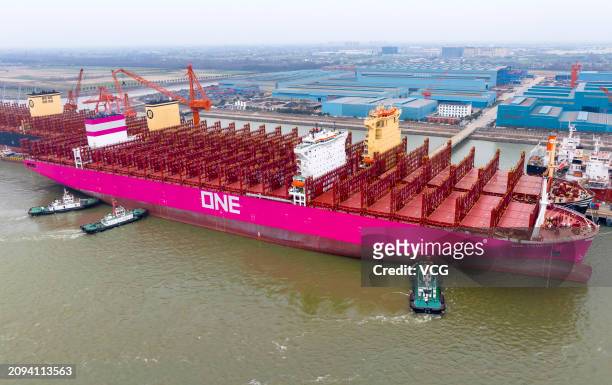 Container ship is assisted by tugboats as it prepares to leave a dockyard of Jiangsu Yangzi-Mitsui Shipbuilding Co., Ltd. On March 18, 2024 in...