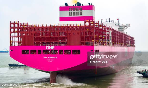 Container ship is assisted by tugboats as it prepares to leave a dockyard of Jiangsu Yangzi-Mitsui Shipbuilding Co., Ltd. On March 18, 2024 in...