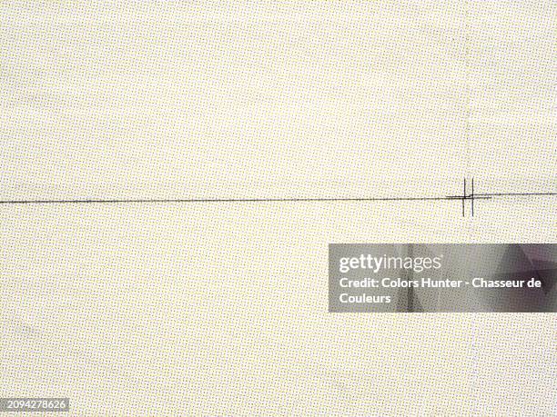 yellow, red and blue dots printed on a white background.close-up of offset-printed posters with print margins visible (black lines) and pasted side by side on a wall in paris, france.sunlight. natural colors. - jornal imagens e fotografias de stock