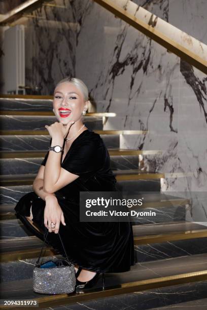 blonde girl with red lips posing on the stairs. - gold high heels stock pictures, royalty-free photos & images