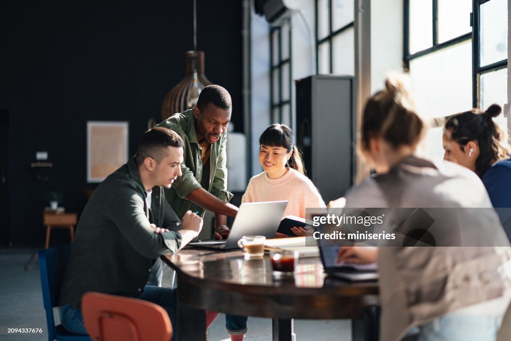 Diverse Team Working Together in Modern Co-Working Space