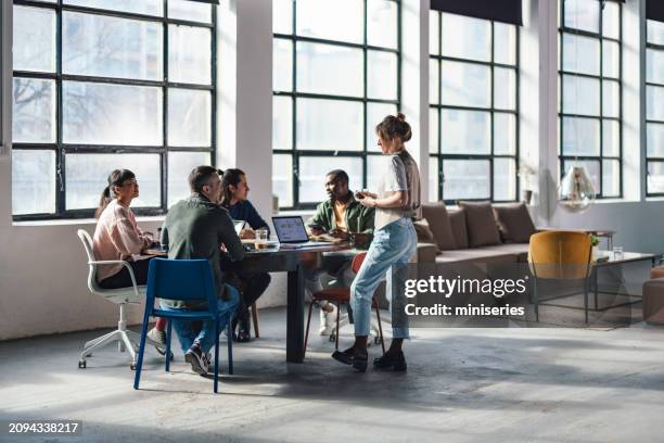 young professionals collaborating in a modern co-working space - casual clothing stock pictures, royalty-free photos & images