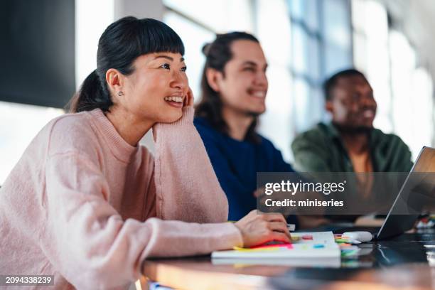 young professionals engaged in a creative co-working space - roupa descontraída imagens e fotografias de stock