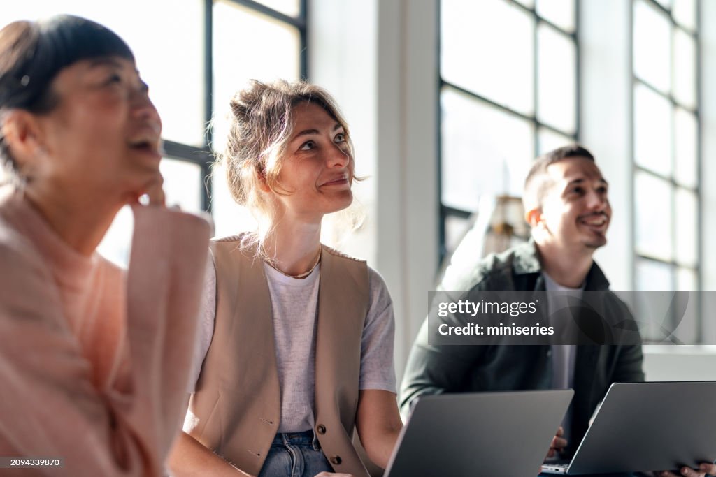 Young Professionals Collaborating in Modern Co-Working Space