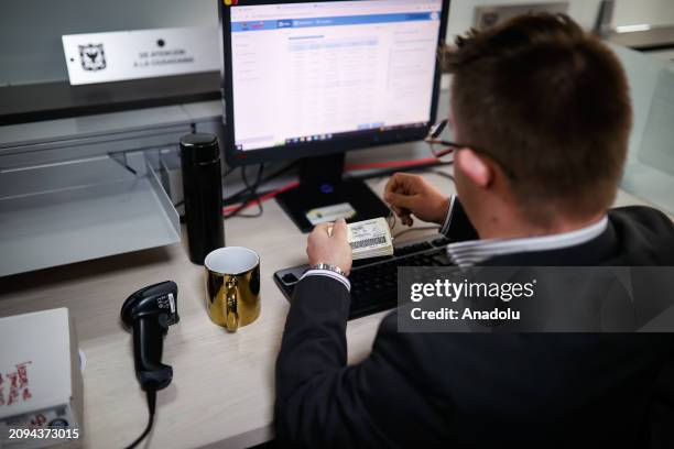 Juan Pablo Dimitri Vergara Cifuentes looks at his computer at his office where he works as the first public official in Bogota with Down syndrome for...