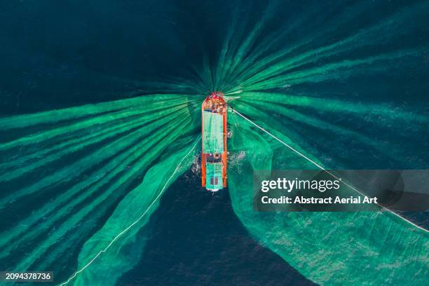 drone photograph looking down on a fishing trawler catching anchovies, vietnam - south china sea fishing stock pictures, royalty-free photos & images
