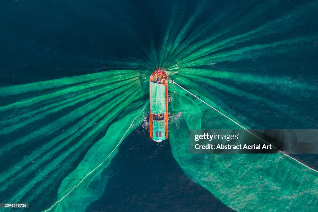 Drone photograph looking down on a fishing trawler catching anchovies, Vietnam