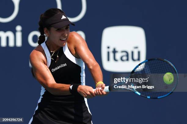 Camila Osorio of Colombia returns a shot to Nadia Podoroska of Argentina during her women's singles qualifying match during the Miami Open at Hard...