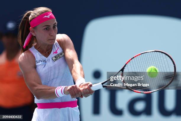 Aleksandra Krunic of Serbia returns a shot to Bernarda Pera of the United States during her women's singles qualifying match during the Miami Open at...