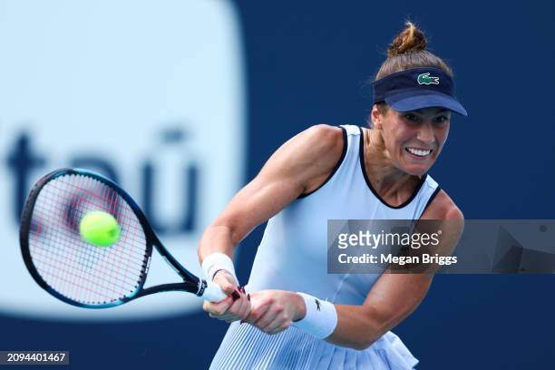 Bernarda Pera of the United States returns a shot to Aleksandra Krunic of Serbia during her women's singles qualifying match during the Miami Open at...