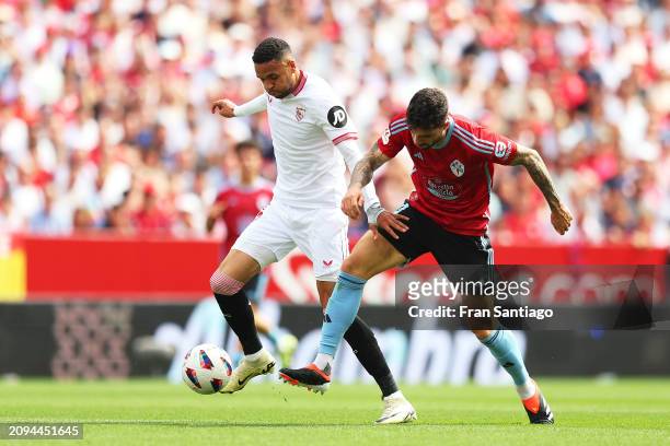 Yousseff En-Nesyri of Sevilla FC competes for the ball with Unai Nunez of Celta Vigo during the LaLiga EA Sports match between Sevilla FC and Celta...