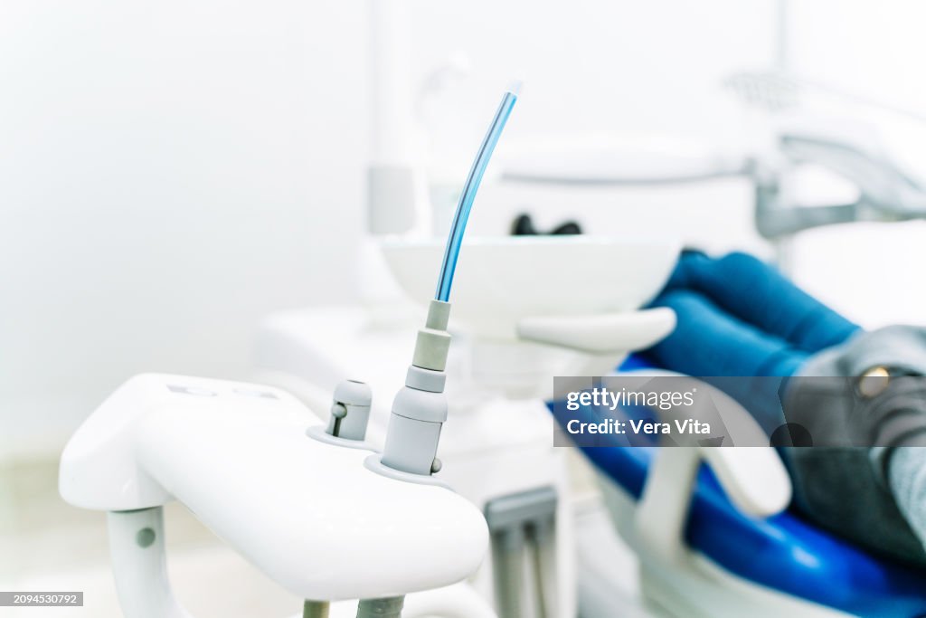 Unrecognizable woman sit at white dental clinic