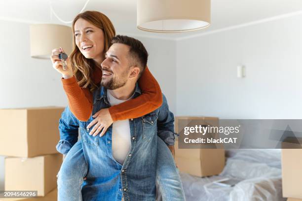 happy couple enjoying their new home - embracing change stock pictures, royalty-free photos & images