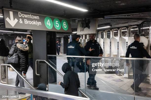 Officers patrol a Manhattan subway station on March 18, 2024 in New York City. Following a surge in crime on the subways, New York Governor Kathy...