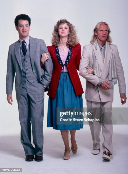 View of, from left, American actors Tom Hanks & Shelley Long, and Russian-American dancer & actor Alexander Godunov as they pose, against a white...