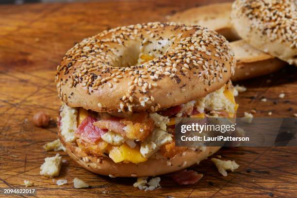 preparing the chopped everything bagel breakfast sandwich - bagel stock pictures, royalty-free photos & images