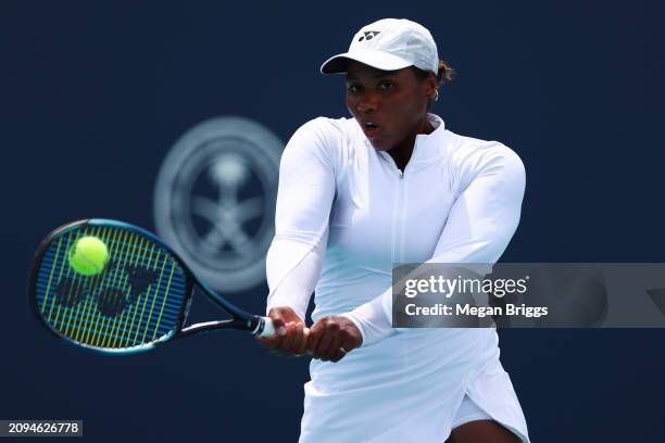 Taylor Townsend of the United States returns a shot to Emina Bektas of the United States during her women's singles qualifying match during the Miami...