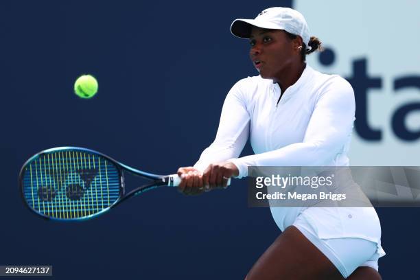 Taylor Townsend of the United States returns a shot to Emina Bektas of the United States during her women's singles qualifying match during the Miami...