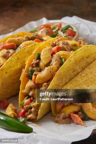 mexican mac and cheese taco's - savoury sauce stock pictures, royalty-free photos & images