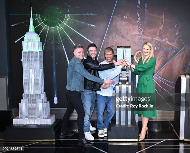 Nicky Byrne, Shane Filan and Kian Egan of Westlife pose with Minister Helen McEntee as they light the Empire State Building in celebration of St....