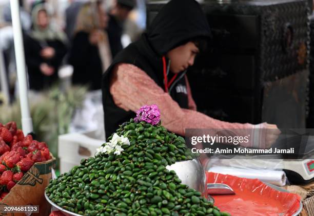 People prepare for the Persian New Year on March 18, 2024 in Tehran, Iran. Nowruz is the Iranian or Persian New Year celebrated by various...