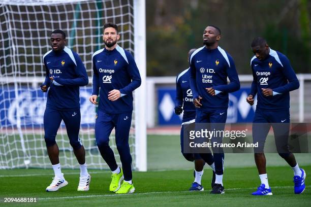 Youssouf Fofana, Olivier Giroud, Marcus Thuram and Randal Kolo Muani of France warm up during a French national team training session part of a...