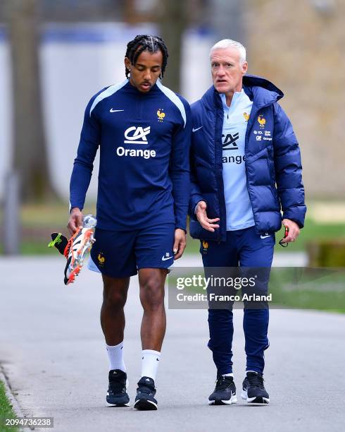 Jules Kounde of France talks with Didier Deschamps, Head coach of France prior to a French national team training session part of a preparation for...