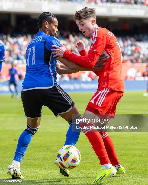 Brian Gutierrez of Chicago Fire battles for the ball with Ariel Lassiter of CF Montreal during a game between CF Montreal and Chicago Fire FC at...