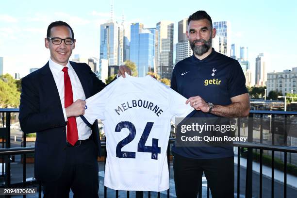 Steve Dimopoulos the Minister for Tourism, Sport and Major Events, Environment, Outdoor Recreation and Mile Jedinak pose with a "Melbourne 24" jersey...