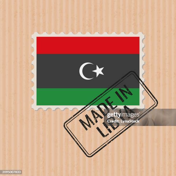 made in libya badge vector. sticker with libyan national flag. ink stamp isolated on paper background. - libyan flag stock illustrations