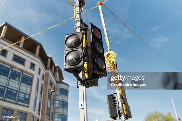 metal pedestrian traffic light pole on the street outside buildings without people with the sky in the background, low angle view - road signal stock pictures, royalty-free photos & images