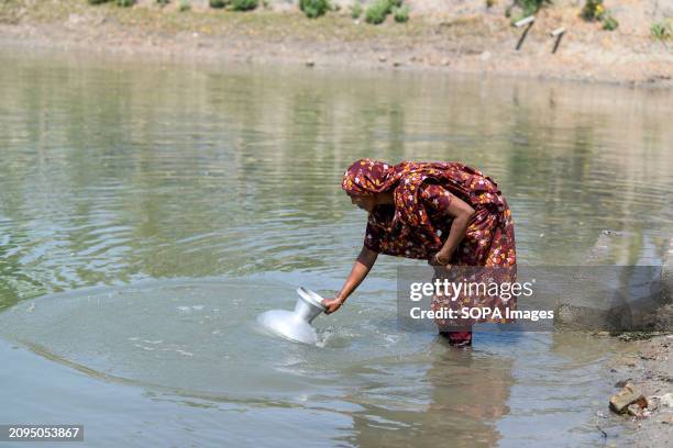 Woman collecting drinking water from a pond at Shyamnagar Gabura in Satkhira district. In Gabura Union, located in Shatkhira District, southern...