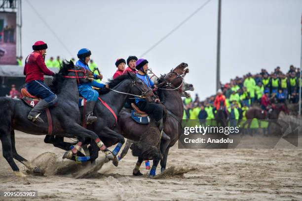 Jockeys wearing traditional clothes, compete during a race on the occasion of Newroz events, which symbolizes the arrival of spring, as it is...