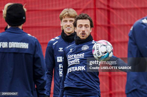 Denmark's midfielder Thomas Delaney and Denmark's Mads Roerslev attend a training session of Denmark's national football team in Helsingoer, Denmark...